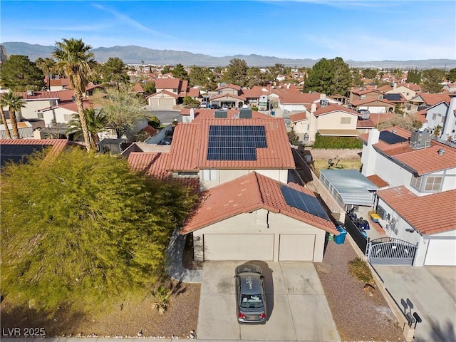 drone / aerial view featuring a residential view and a mountain view