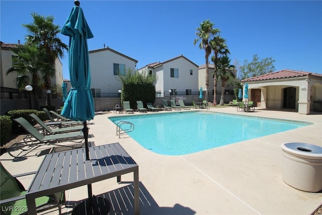 pool featuring a patio area and fence