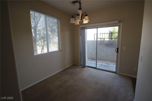 unfurnished dining area featuring baseboards, visible vents, a chandelier, and carpet flooring