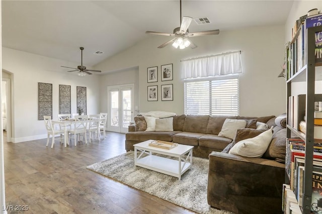 living area featuring french doors, visible vents, ceiling fan, and wood finished floors