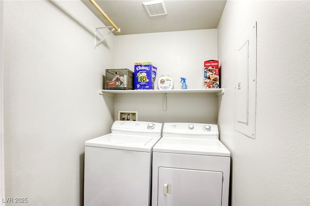 washroom featuring laundry area, visible vents, and separate washer and dryer