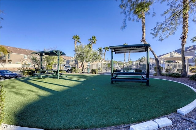 surrounding community featuring a residential view, fence, and a lawn