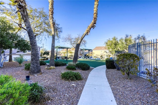 surrounding community featuring fence and a yard