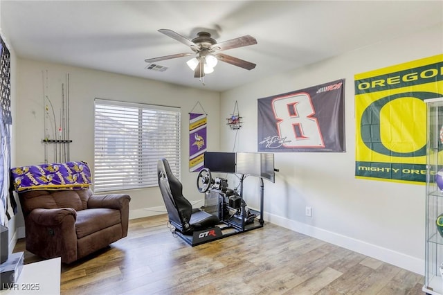 office space featuring ceiling fan, wood finished floors, visible vents, and baseboards