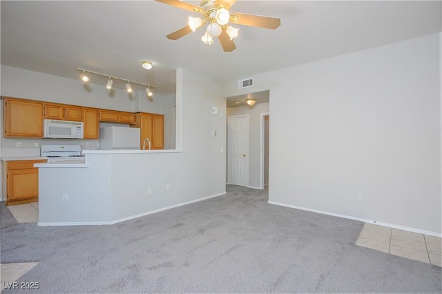 unfurnished living room with baseboards, ceiling fan, visible vents, and light colored carpet