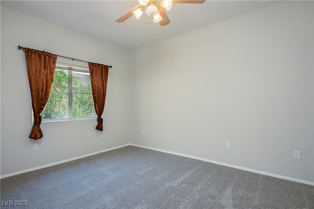 empty room featuring baseboards, dark colored carpet, and a ceiling fan