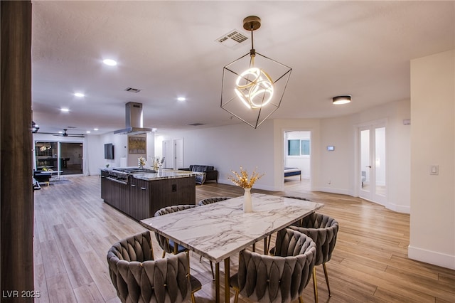 dining area with light wood-style floors, recessed lighting, visible vents, and baseboards