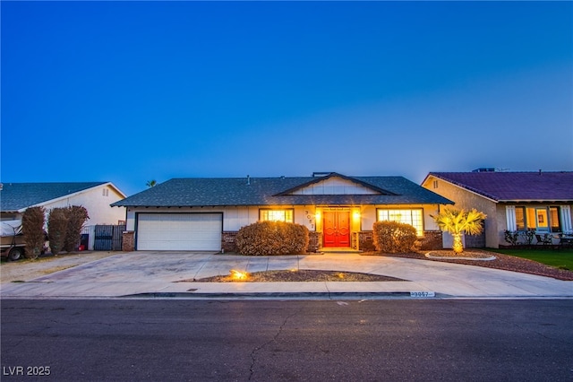 single story home with concrete driveway and an attached garage