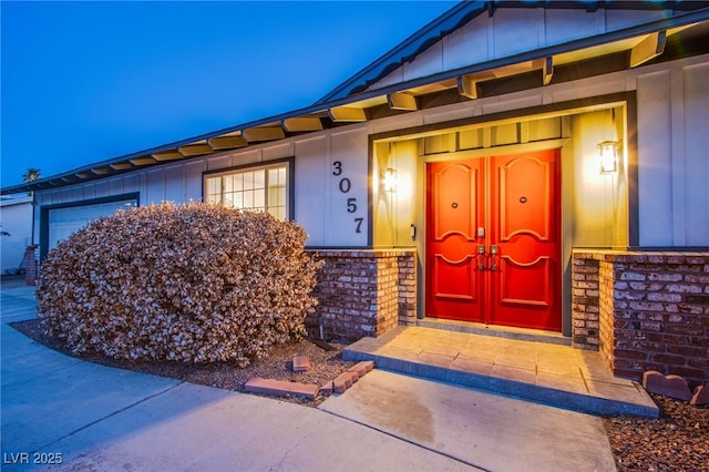 entrance to property featuring board and batten siding and stone siding