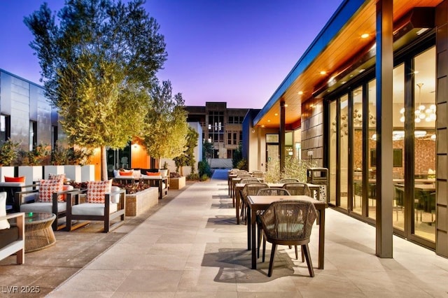 patio terrace at dusk featuring outdoor dining area