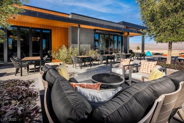 view of patio / terrace featuring an outdoor hangout area and outdoor dining space