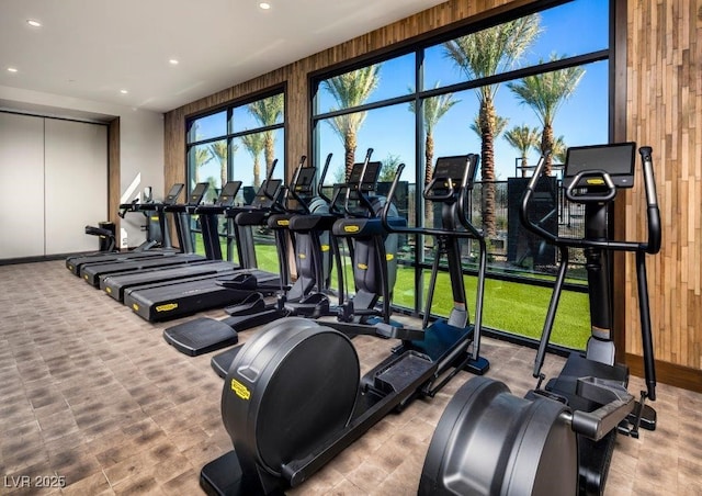 gym with wood walls and recessed lighting