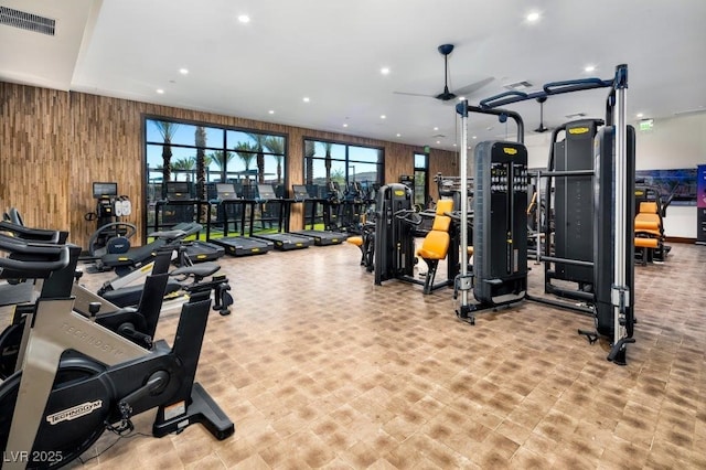 workout area with recessed lighting, visible vents, and wood walls