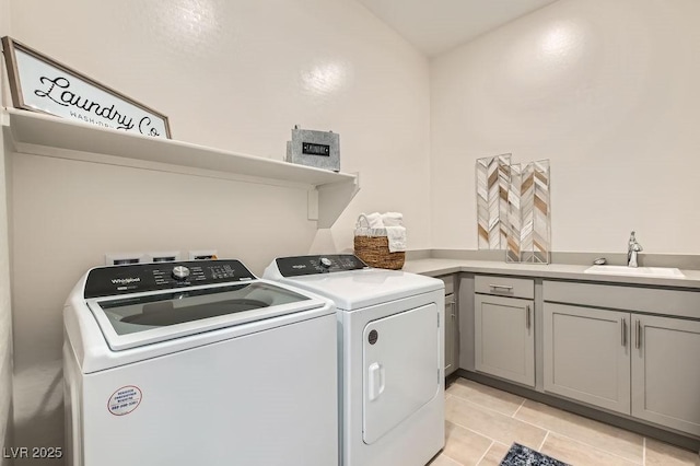 laundry room featuring independent washer and dryer, cabinet space, a sink, and light tile patterned floors