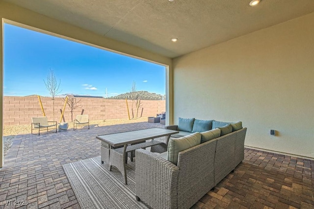 view of patio featuring a fenced backyard, an outdoor living space, and outdoor dining space