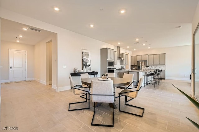 dining area with baseboards, visible vents, and recessed lighting