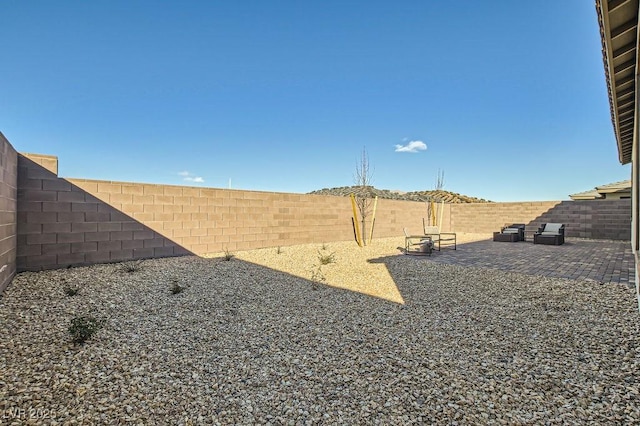 view of yard featuring a patio and a fenced backyard