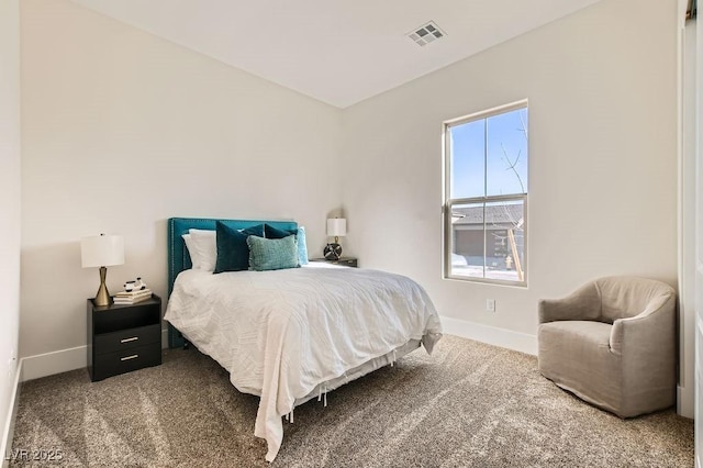 carpeted bedroom with visible vents and baseboards