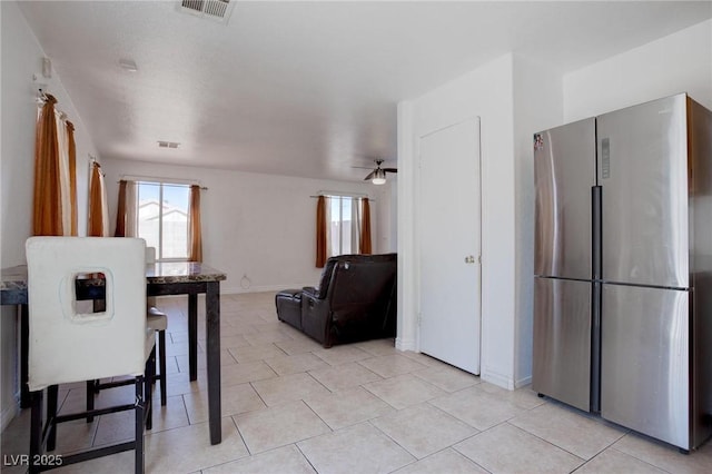 dining space with light tile patterned floors, baseboards, and visible vents