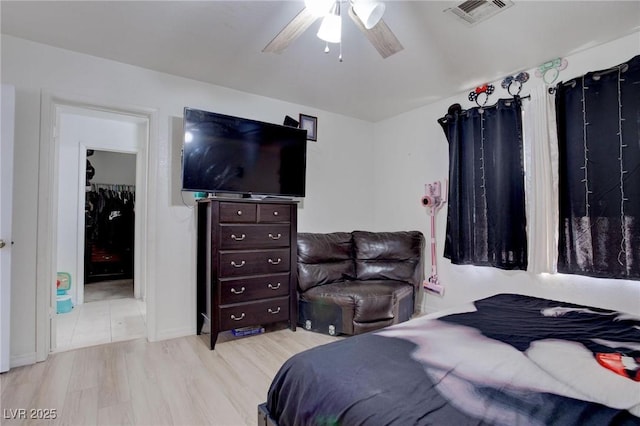 bedroom with ceiling fan, light wood-type flooring, and visible vents