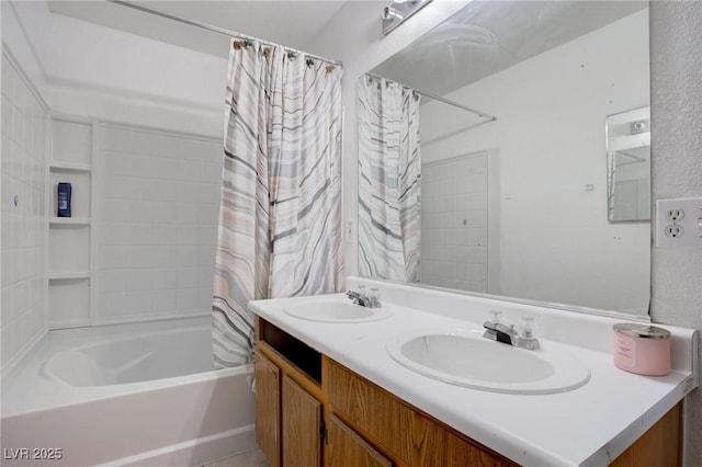 bathroom featuring double vanity, shower / bath combo, and a sink