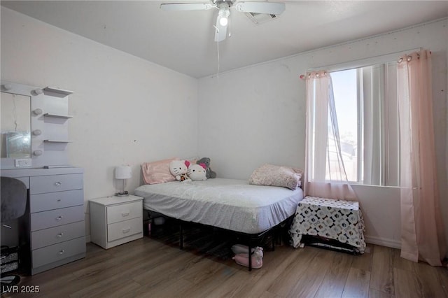 bedroom with ceiling fan and wood finished floors