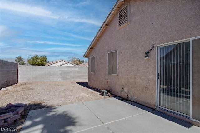 view of property exterior featuring a patio area, a fenced backyard, and stucco siding