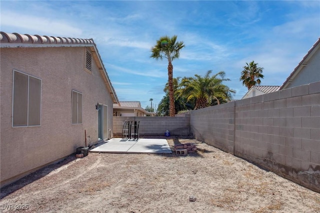 view of yard with a patio area and a fenced backyard