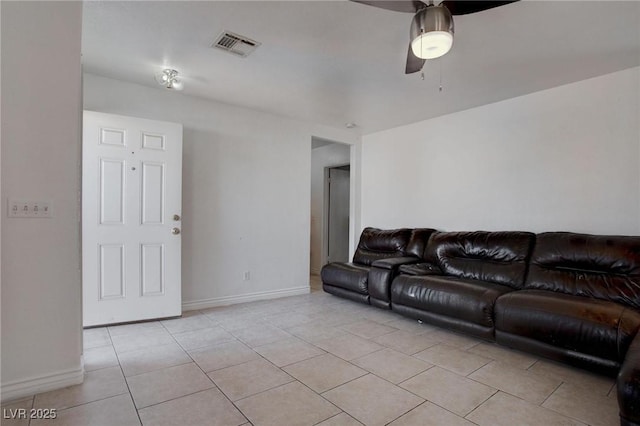 living area featuring light tile patterned floors, ceiling fan, visible vents, and baseboards