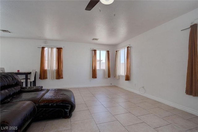 living room featuring visible vents, baseboards, and light tile patterned floors