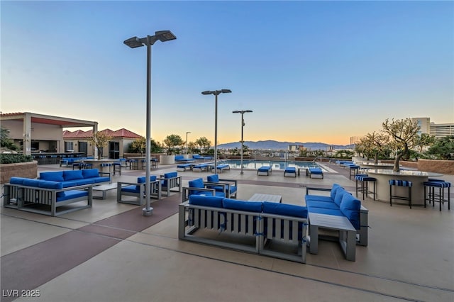 patio terrace at dusk featuring an outdoor hangout area