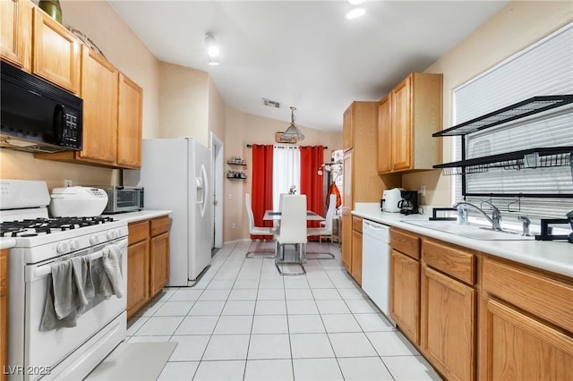 kitchen with white appliances, light countertops, and light tile patterned floors