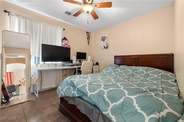 tiled bedroom featuring a ceiling fan and visible vents