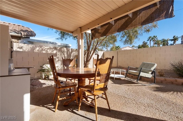 view of patio featuring outdoor dining area and a fenced backyard