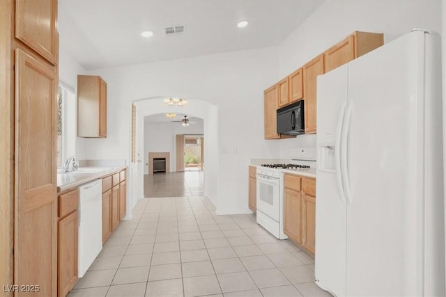 2137 Hidden Ranch Ter, Henderson, NV 89052 - kitchen featuring white appliances, light countertops, light brown cabinets, ceiling fan, and a fireplace