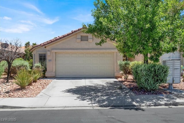 2137 Hidden Ranch Ter, Henderson, NV 89052 - view of front of home featuring driveway, a garage, stucco siding, and a tile roof