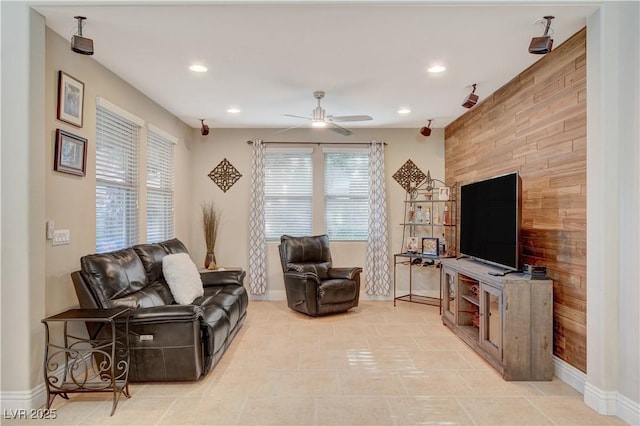 living room featuring a ceiling fan, recessed lighting, and baseboards