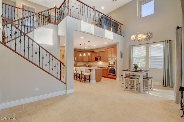 living area featuring a chandelier, stairway, recessed lighting, and baseboards