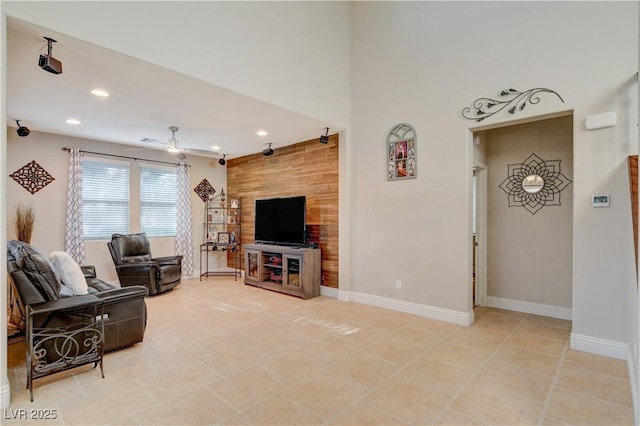 living area featuring light tile patterned floors, recessed lighting, a ceiling fan, and baseboards