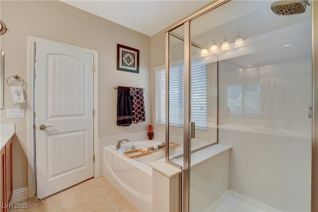 full bath with a stall shower, a garden tub, vanity, and tile patterned floors