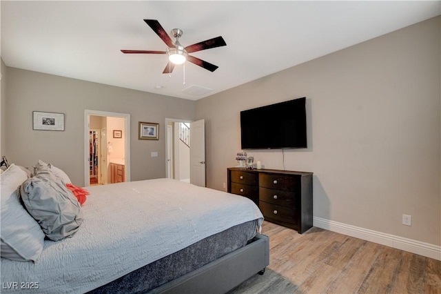 bedroom with a ceiling fan, light wood-style flooring, baseboards, and ensuite bathroom