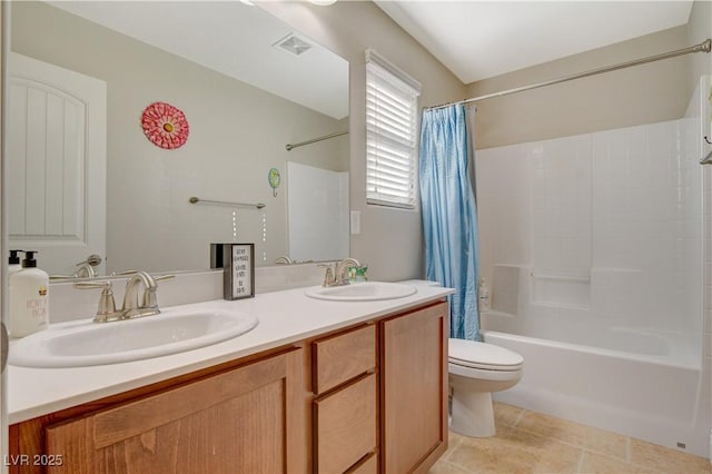 bathroom featuring toilet, a sink, visible vents, and tile patterned floors