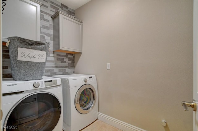 laundry room with baseboards, light tile patterned floors, cabinet space, and washer and dryer