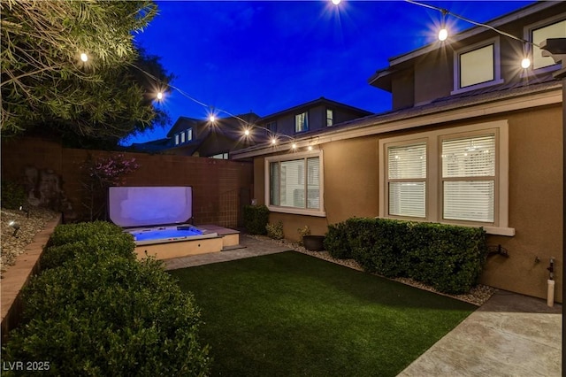 exterior space featuring a yard, fence, and stucco siding