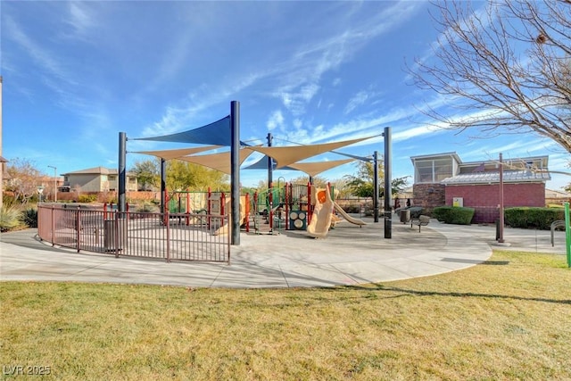 view of community with playground community, a yard, and fence