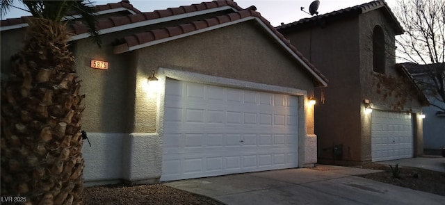 garage featuring concrete driveway