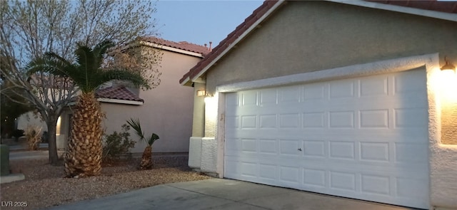 garage featuring concrete driveway