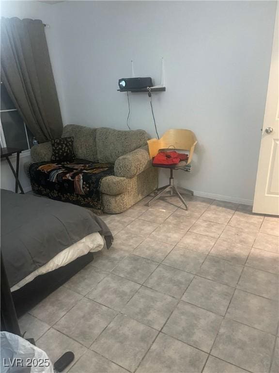 living room featuring baseboards and light tile patterned flooring