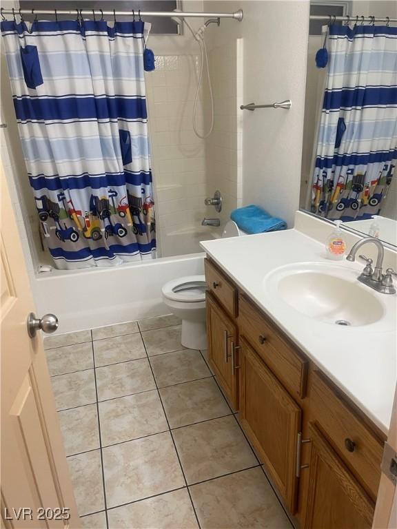 full bath with toilet, vanity, tile patterned flooring, and shower / bath combo with shower curtain