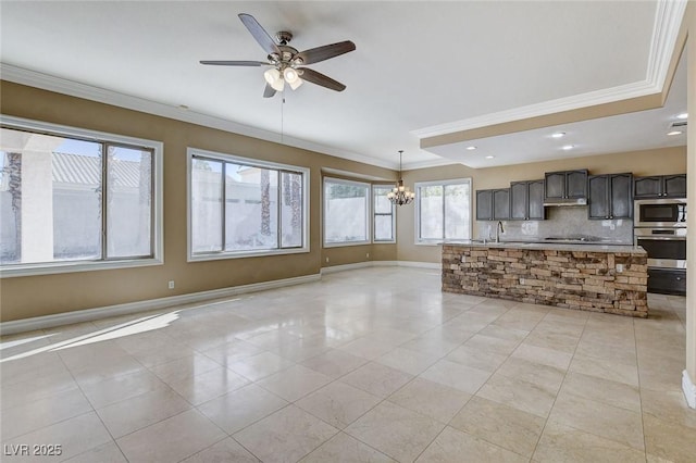 unfurnished living room featuring light tile patterned flooring, crown molding, baseboards, and ceiling fan with notable chandelier